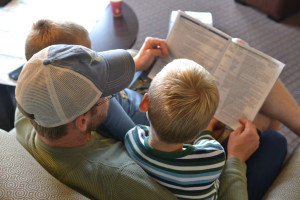 Father reading to sons